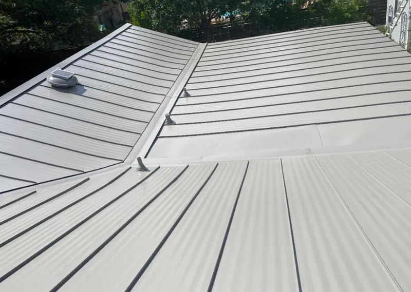 Solar attic fan installed on a metal roof for Roof Ventilation in New Haven