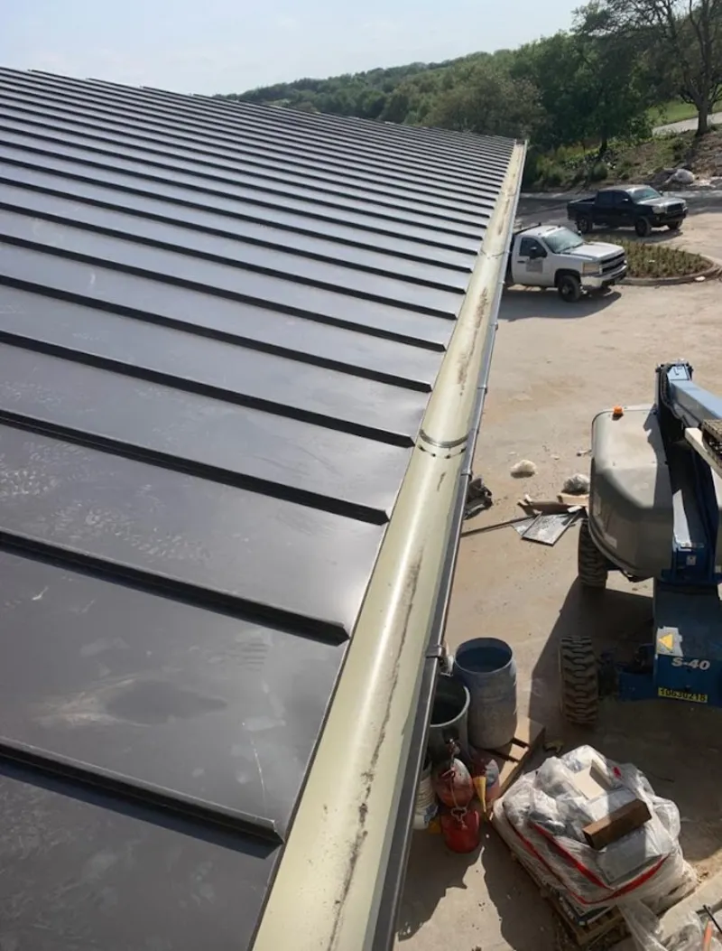 Standing seam panel and gutter detail on a metal roofing jobsite in New Haven